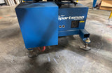 Blue Sportsman air compressor on a concrete floor