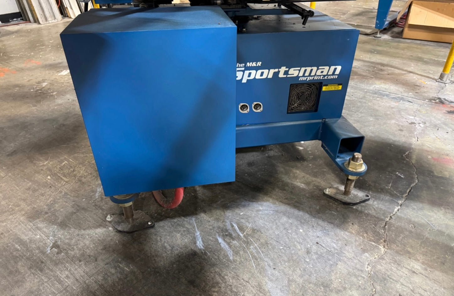 Blue Sportsman air compressor on a concrete floor