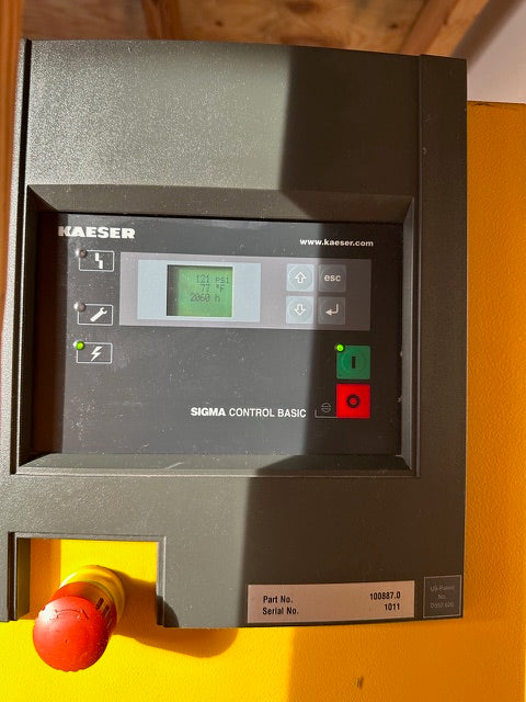 Control panel with digital display and buttons on a yellow background