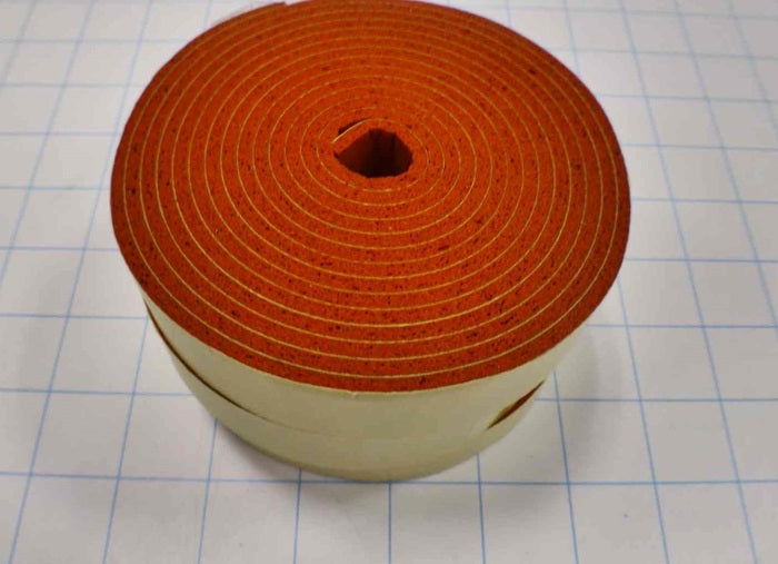 Roll of orange tape on a white grid background